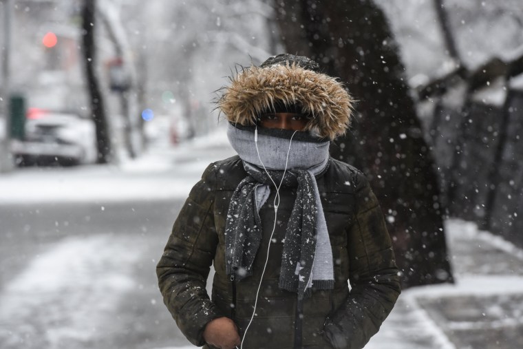 Image: A person walks through the snow during a storm in the Brooklyn borough of New York City