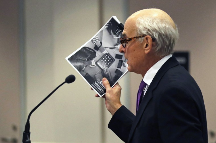 Image: Attorney Steven M. Gordon, who represents lottery winner "Jane Doe" holds up an annual report