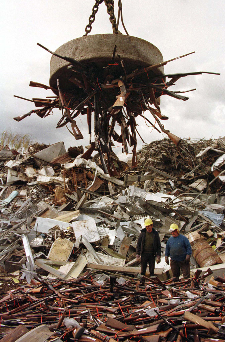 Image: A giant magnet picks up prohibited firearms at a scrap-metal yard in Sydney