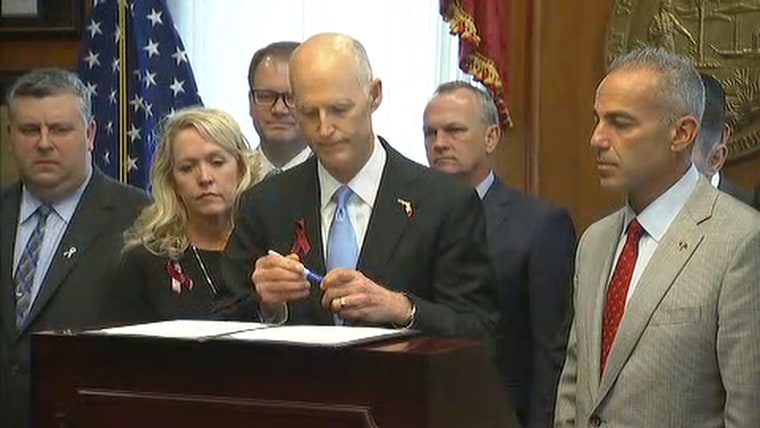 Image: Florida Gov. Rick Scott signs the Marjory Stoneman Douglas High School Public Safety Act