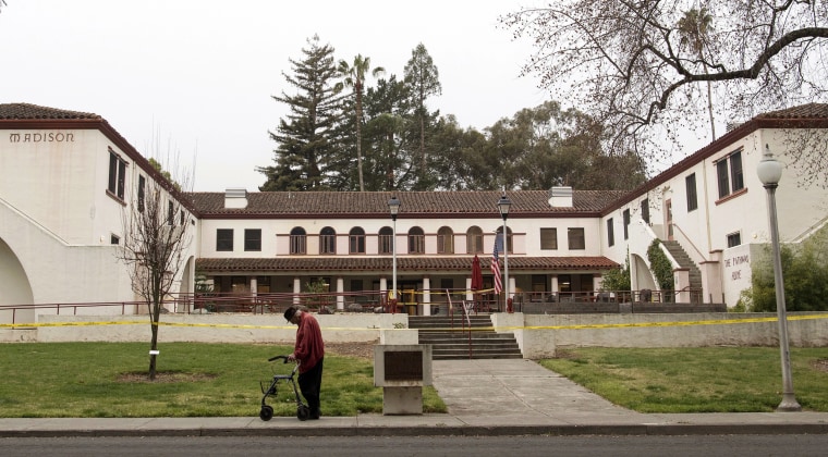 Image: A man passes the Veterans Home of California the morning after a hostage situation in Yountville, California, on March 10, 2018.