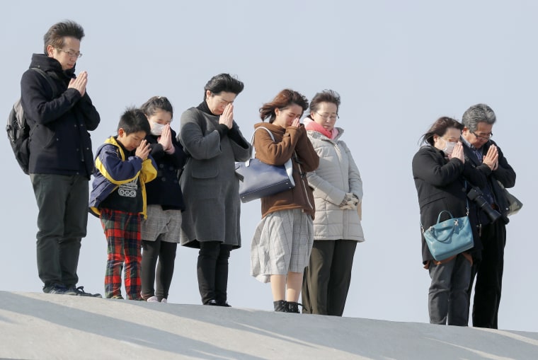 Image: People pray for the victims killed by a tsunami at 2:46 pm local time, that came after a 9.0-magnitude earthquake shook northern Japan and triggered a subsequent tsunami, seven years ago, at Arahama district, Miyagi Prefecture, on March 11, 2018.