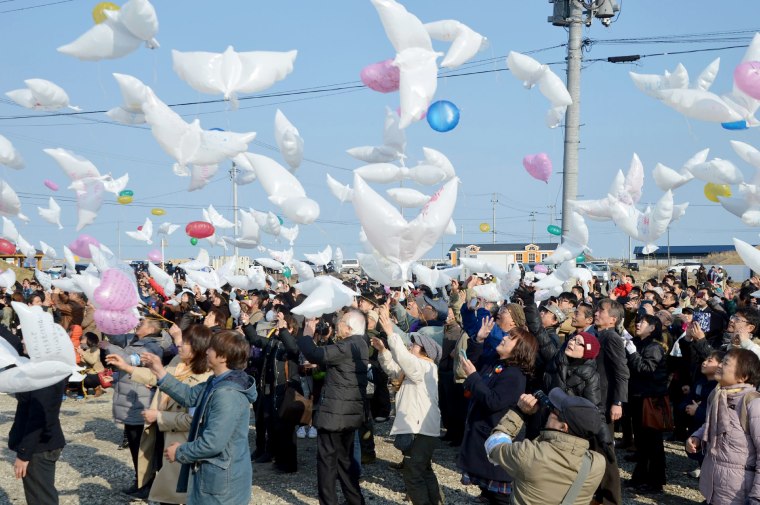 Image: Residents fly dove-shape balloons to mourn victims of the 2011 tsunami and earthquake disaster at Natori in Miyagi prefecture on March 11, 2018.