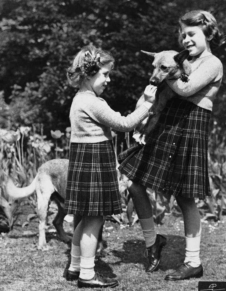 Princess Elizabeth, right, holds her Corgi with her sister Princess Margaret Rose on July 5, 1936.