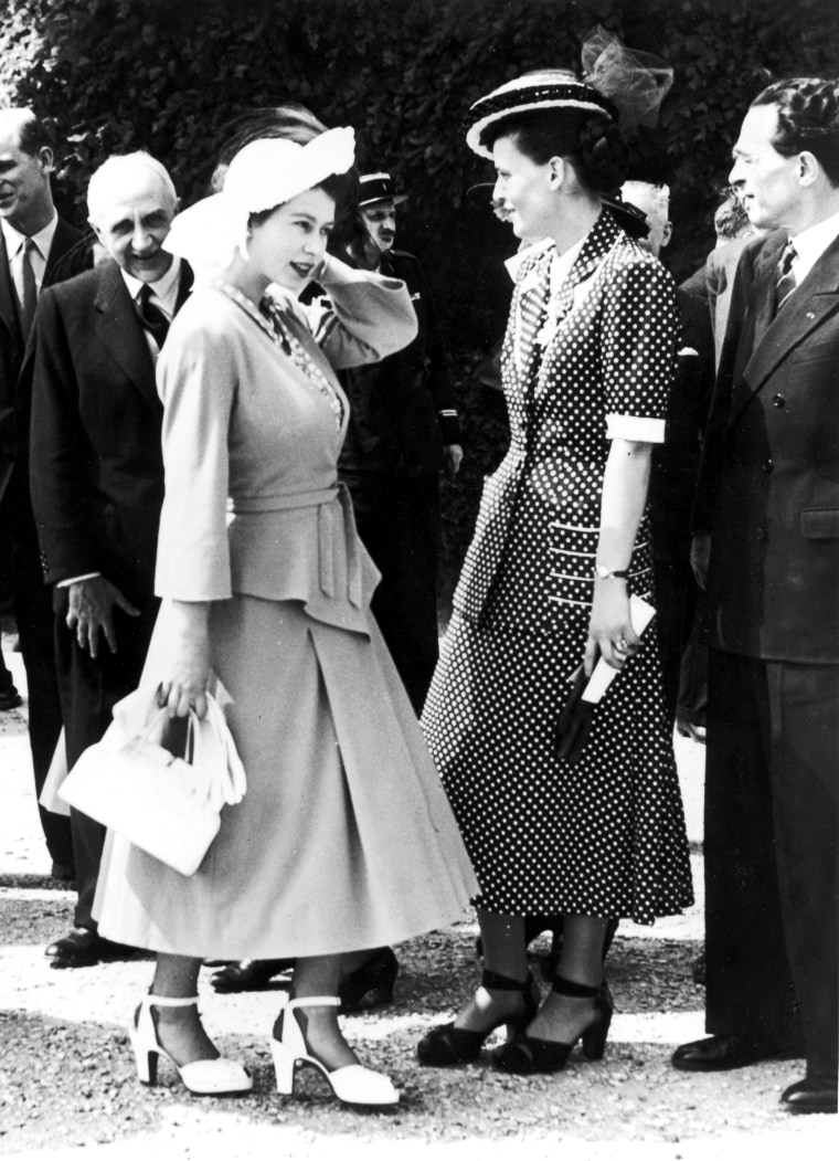 Princess Elizabeth talks to to Mme Bidault, wife of the French minister Georges Bidault,  in the garden of the Palace of Versailles.