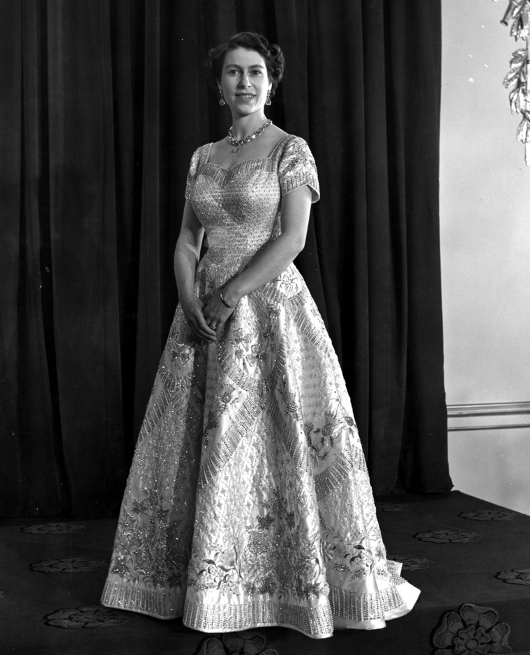 For her coronation ceremony on June 4, 1953, more than a year after her father's death, the queen again turned to Norman Hartnell to design her gown. Hartnell, who had designed her wedding dress, spent months embroidering the emblems of Great Britain and the Commonwealth on the white satin. The dress was also encrusted with pearls and crystals.