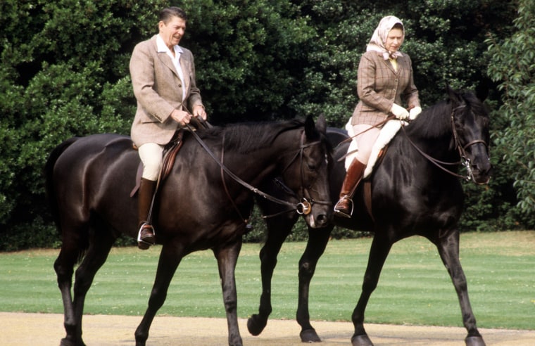 Queen Elizabeth takes President Ronald Reagan on an hour-long ride through the grounds of Windsor Castle in June 1982. Known to be an accomplished rider, the queen is often pictured in her traditional riding gear - knee-high boots, tweed jacket and scarf.