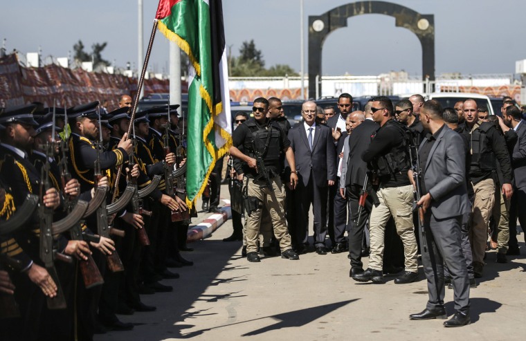 Image: Palestinian Prime Minister Rami Hamdallah is greeted by police forces