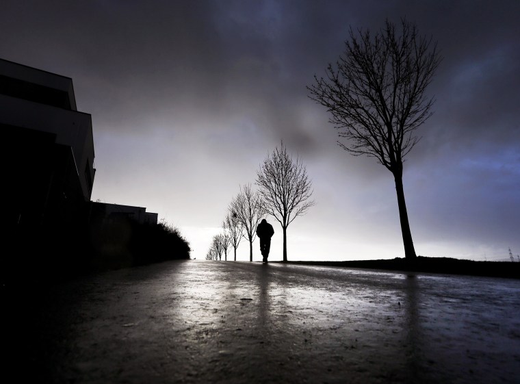 Image: A man walks by trees in the outskirts of Frankfurt, Germany