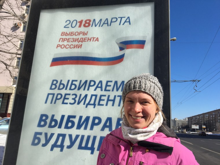 Anna Popova, 31, next to an election billboard on Kutuzovsky Avenue in central Moscow, Russia on March 18, 2018.