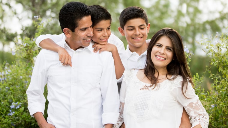 Cheerful family with two teen boys smiling