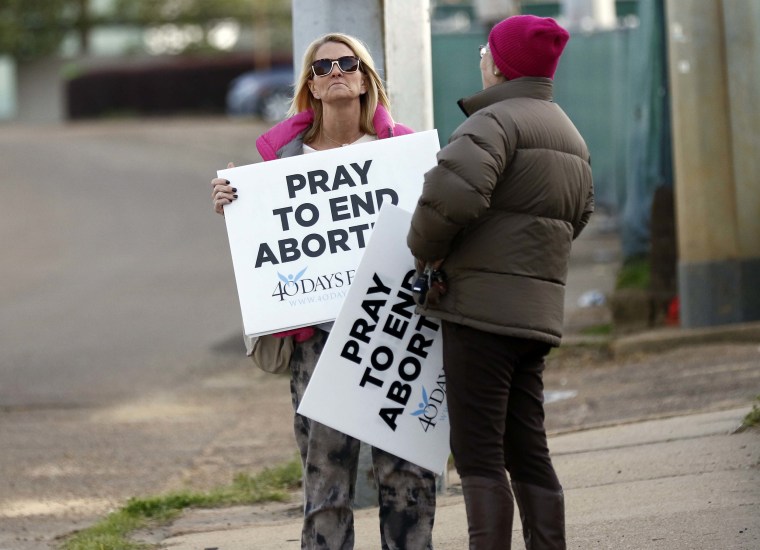 Image: Kami Bullock, left, and Barbara Beavers, both anti-abortion supporters