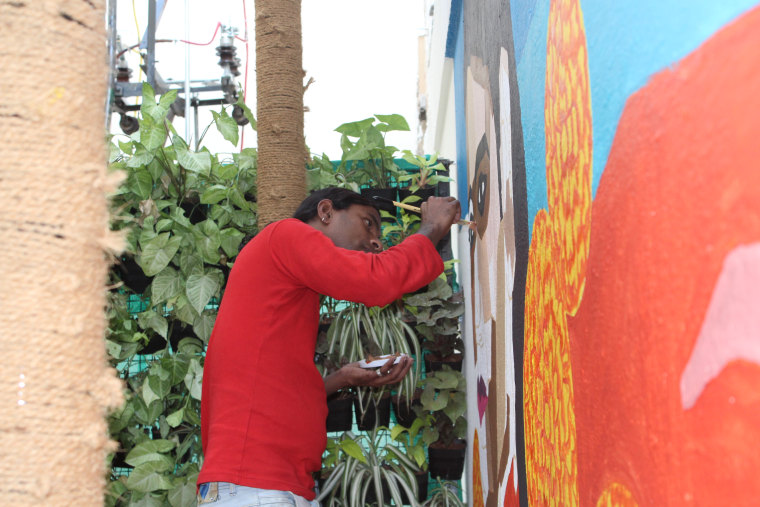 Purushi painting a mural in Bangalore, India, in March 2018.