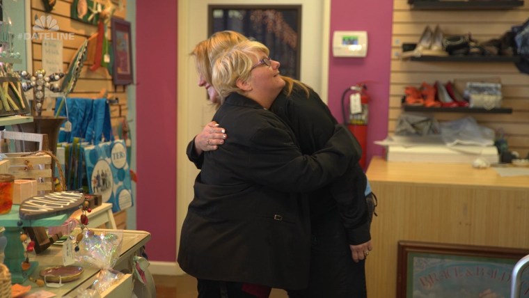 Shaunda Anaya, store manager of TERI Inspired Resale, hugs Heather, a store employee.