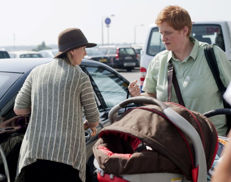 In this July 14, 2011 file photo, Cynthia Nixon, left, and her future spouse Christine Marinoni, right, arrive with their son Max Ellington Nixon-Marinoni in a stroller to the international airport in Budapest, Hungary.