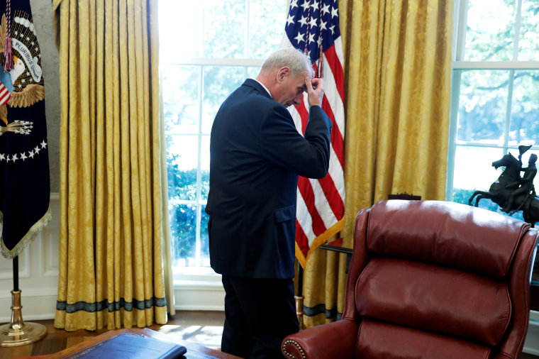 Image: White House Chief of Staff Kelly waits behind the Resolute Desk as U.S. President Donald Trump delivers remarks to reporters