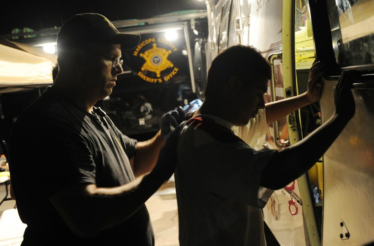 Image: An illegal immigrant is processed by Sheriff's Deputies working for Maricopa County sheriff Joe Arpaio