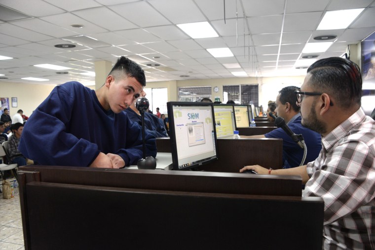 Image: An immigrant deported from the U.S. is registered by migration authorities in Guatemala City