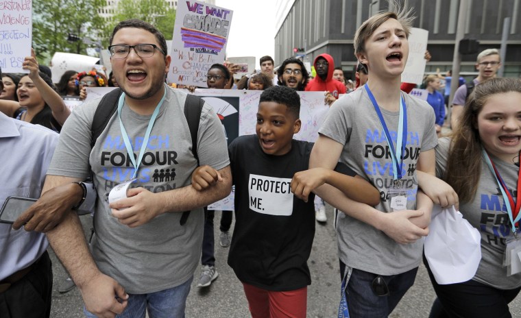 Dezmond Floyd, center left, joins in the march in downtown Houston.