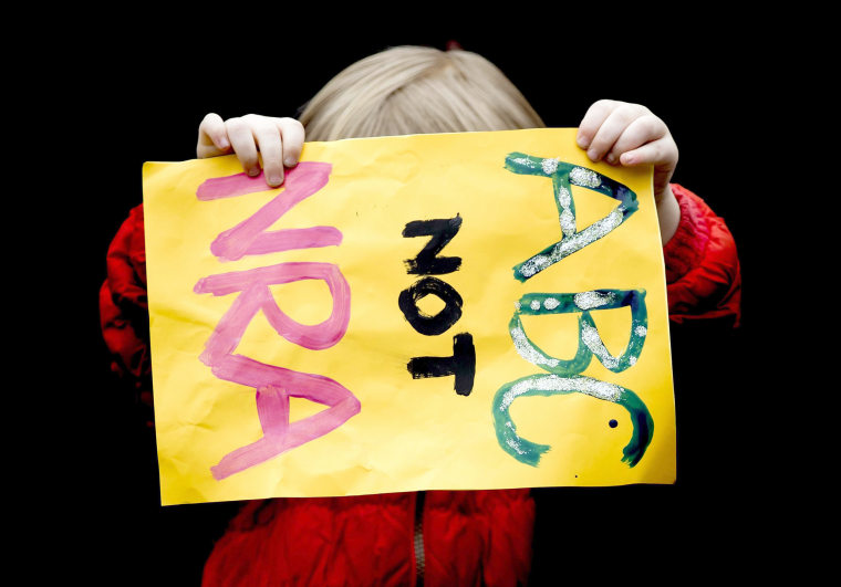 A young demonstrator holds a sign that reads 'ABC not NRA' during a rally calling for stronger gun control in the United States, at the Museum square in the center of Amsterdam, The Netherlands.