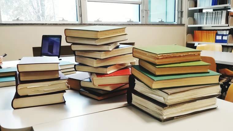 Image: Close-Up Of Hardcover Book Stacks On Table In Library