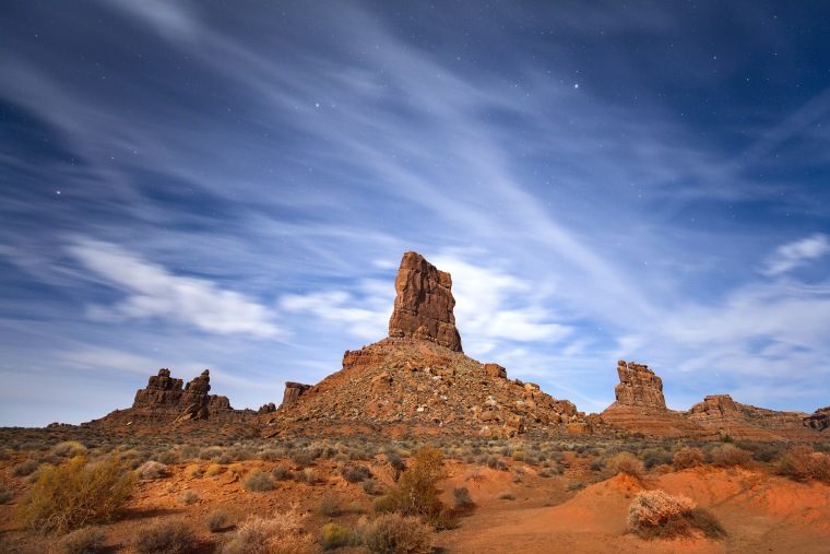 Image: Sandstone buttes rise from the Valley of the Gods under a full moon in Bears Ears National Monument