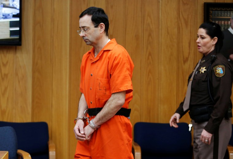 Image: Larry Nassar, a former team USA Gymnastics doctor who pleaded guilty in November 2017 to sexual assault charges, enters the courtroom during his sentencing hearing in the Eaton County Court in Charlotte, Michigan,