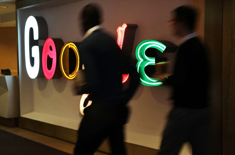 Image: People walk into Google's New York offices