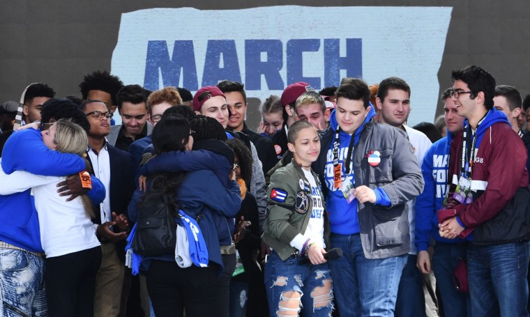 Image: Marjory Stoneman Douglas High School student Emma Gonzalez, center right,  gathers with other students