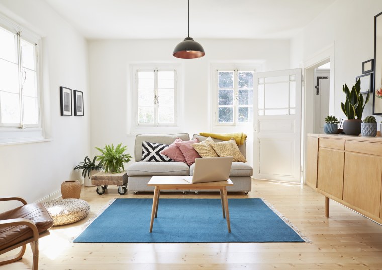 Image: Laptop on coffee table in a modern living room of an old country house