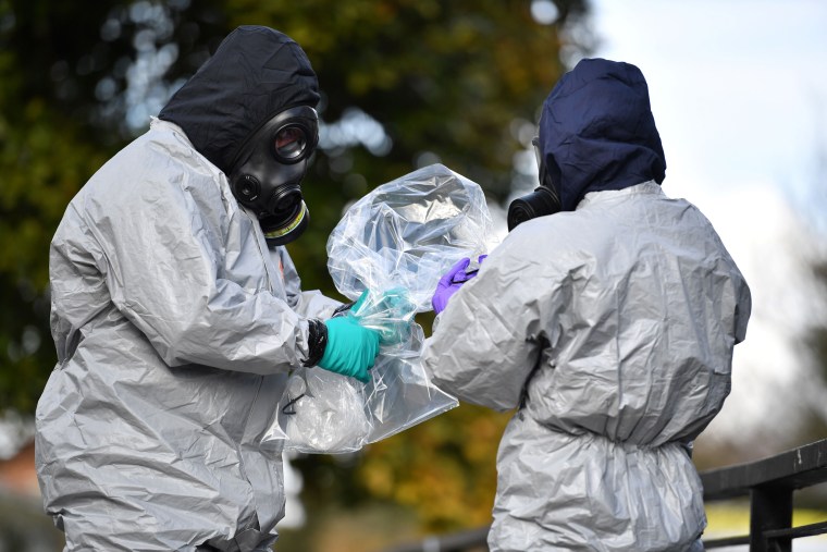 Image: Officials bag samples after swabbing railings near the Maltings shopping center