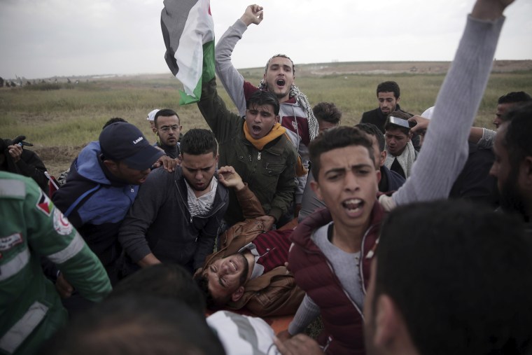 Image: Palestinian protesters carry a wounded man was shot by Israeli troops in Gaza