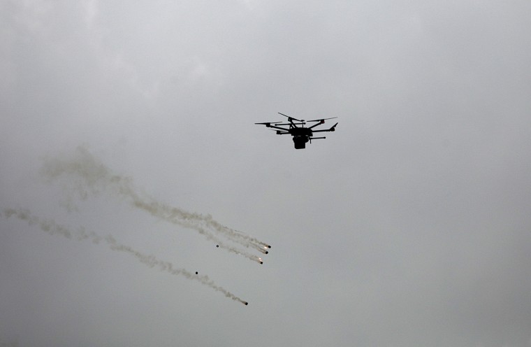 An Israeli drone drops tear-gas grenades over protesters in the eastern Beit Hanun town, in the northern Gaza Strip on March 30.