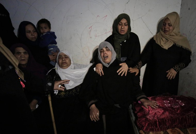 The mother of Palestinian Ibrahim Abu Shaer mourns during his funeral on March 31.