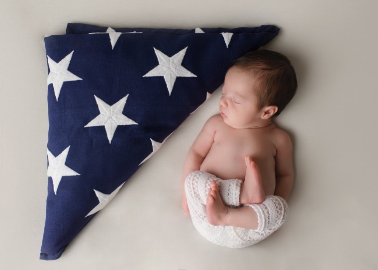 Baby poses in military uniform of father she'll never meet