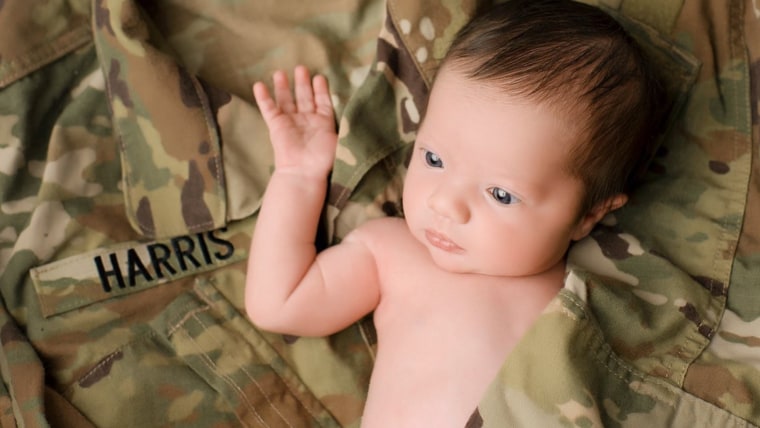 Baby poses in military uniform of father she'll never meet