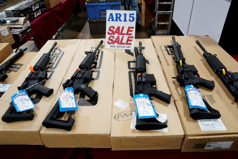Image: AR-15 rifles are displayed for sale at a gun show