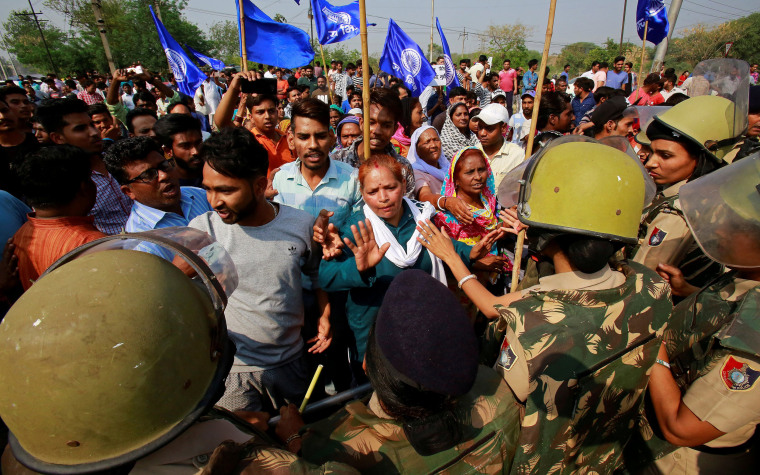 Image: Police try to stop dalit community members during a protest