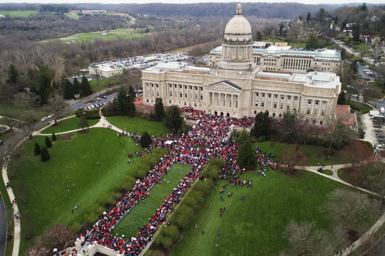 Image: Thousands of teachers gather during a rally for education funding and changes to their pension system