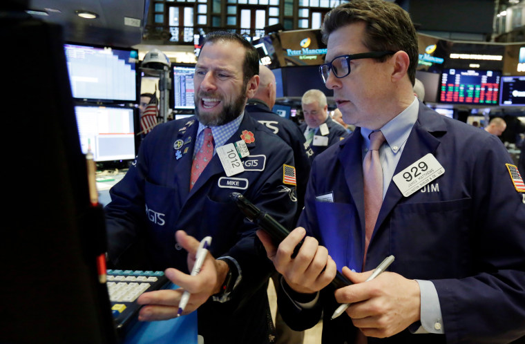Image: Specialist Michael Pistillo, left, and trader James Matthews work on the floor of the New York Stock Exchange