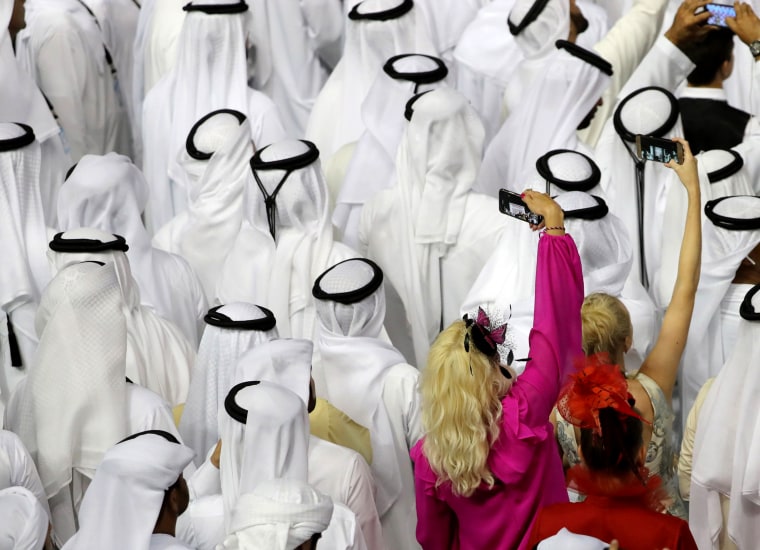 Spectators look on as the Crown Prince of Dubai, Sheikh Hamdan bin Mohammed bin Rashid al-Maktoum presents the Dubai World Cup to Jockey Christophe Soumillon at the Meydan Racecourse in Dubai on March 31.