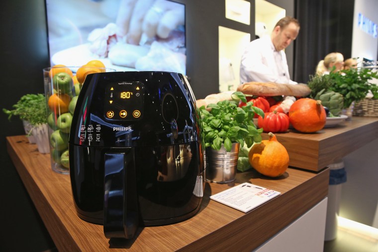 Image: An Airfryer french fries maker stands on display at the Philips stand