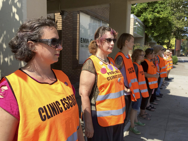 Image: Meg Stern, left, and other escort volunteers line up outside the EMW Women's Surgical Center in Louisville, Kentucky, July 17, 2017.