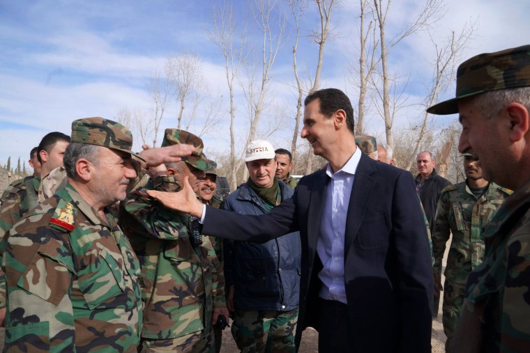 Image: Syrian President Bashar al-Assad shakes hands with government troops in Eastern Ghouta
