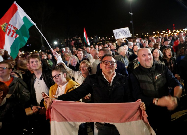 Image: Supporters of Fidesz party react after the announcement of the preliminary results of parliamentary election in Budapest