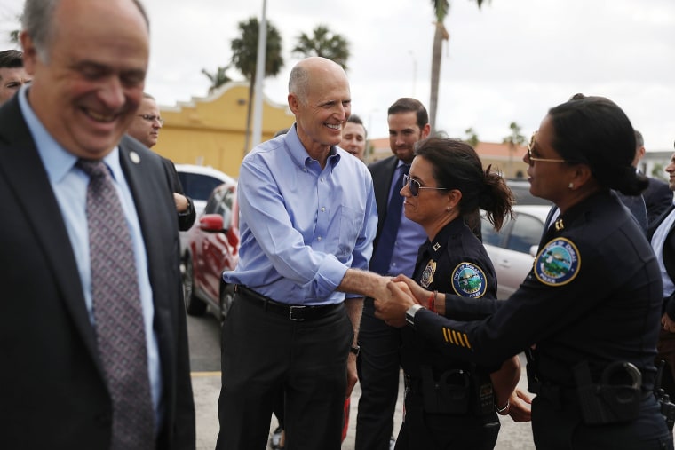 Image: Florida Governor Rick Scott is greeted as he arrives at Restaurant El Arepazo