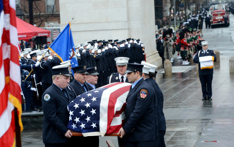 Image: FDNY honor guard carry the flag-draped coffin of FDNY Fire Marshal Capt. Christopher "Tripp" Zanetis during his funeral in Washington Square Park on March 29, 2018 in New York City.