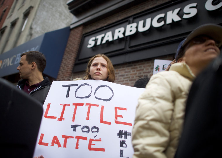 Image: Protester Soren Mcclay, 14, holds a sign outside a Center City Starbucks in Philadelphia.
