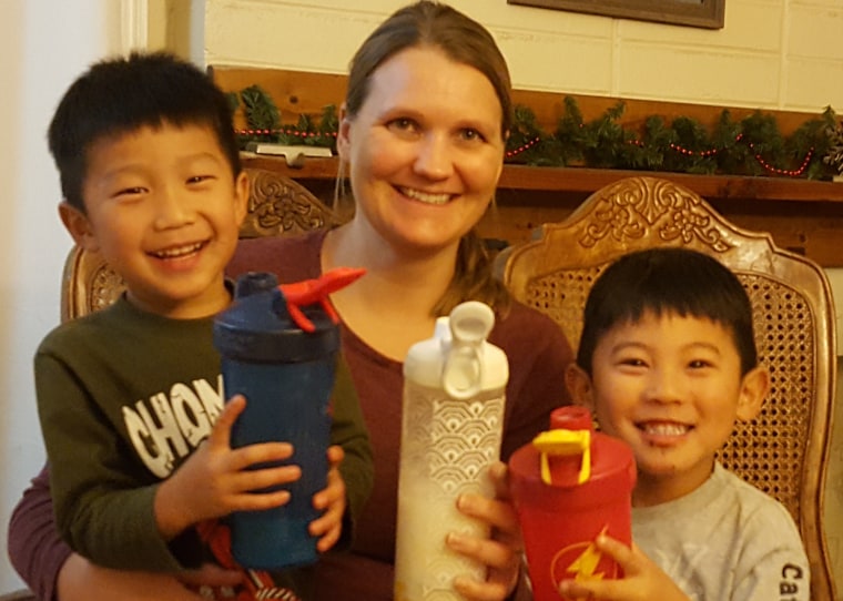 Smith drinking her special PKU formula with two of her sons.