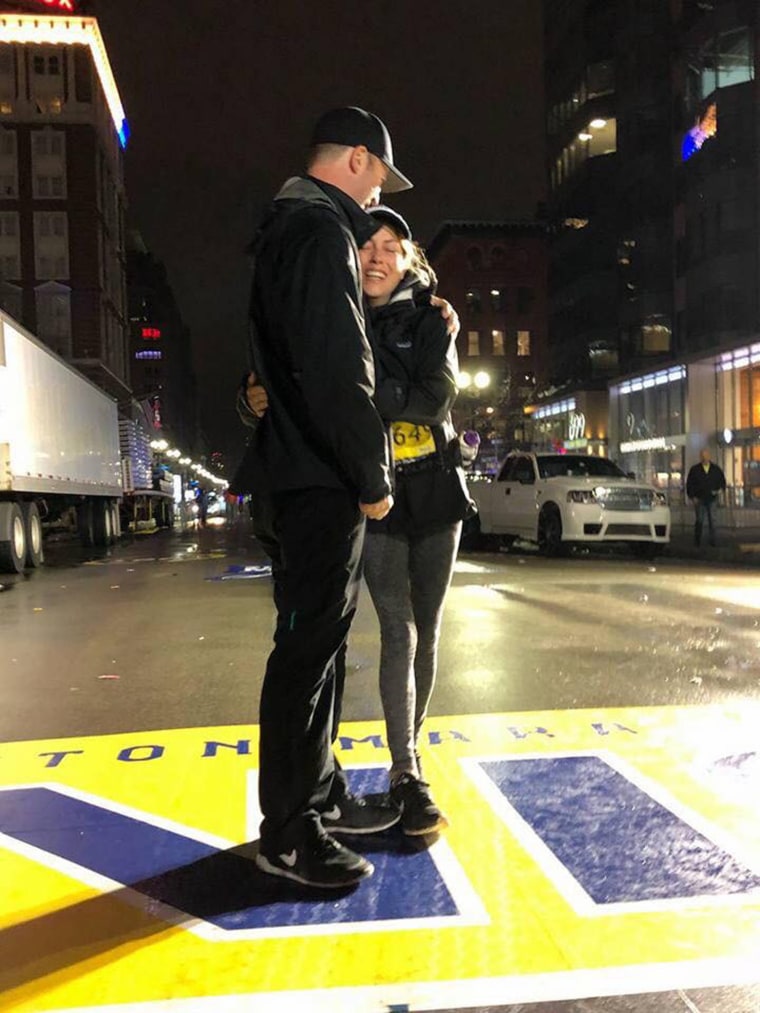 Mary Shertenlieb and her husband cross Boston Marathon finish line